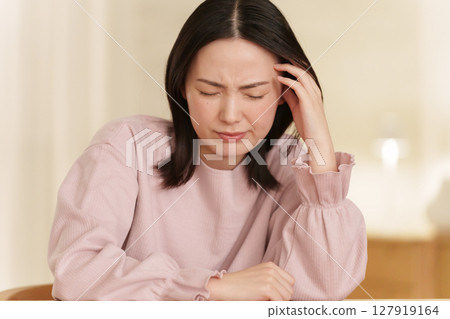 Woman suffering from headache at night 127919164