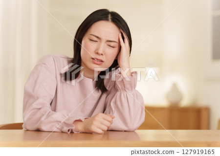 Woman suffering from headache at night 127919165