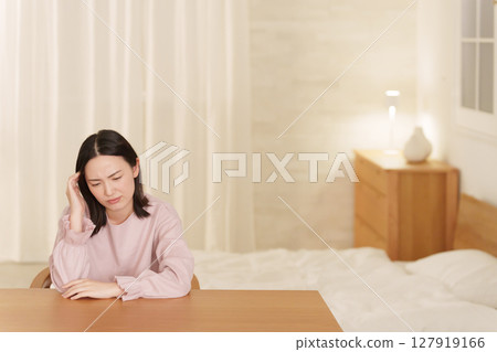 Woman suffering from headache at night 127919166