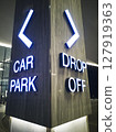 Close-up illuminated signs of car parking and drop-off point on the building 127919363