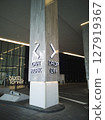 View of illuminated signs of car parking and drop-off point on the building column of shopping mall 127919367