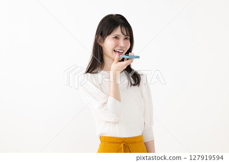 Woman talking to smartphone, voice control Woman talking to smartphone, voice control 127919594