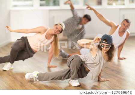 Group of dancers having break dance training at dance studio Group of dancers having break dance training at dance studio 127919648