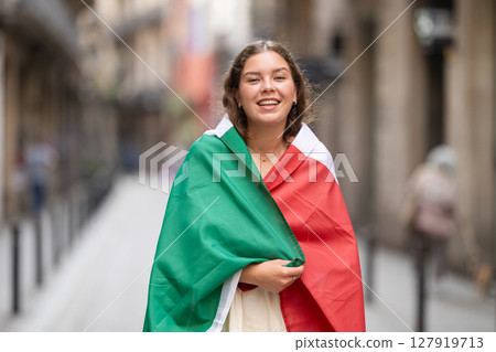 Portrait of woman with Italy flag on street of summer city 127919713
