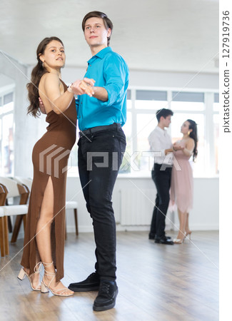 Tango performed by young couple in choreographic studio Tango performed by young couple in choreographic studio 127919736