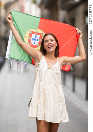 Young woman with Portuguese flag on city street Young woman with Portuguese flag on city street 127919771