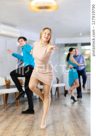 Dance training in dance studio - men and women of different ages learn dances from different eras Dance training in dance studio - men and women of different ages learn dances from different eras 127919790