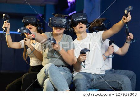Group of excited young people playng virtual game Group of excited young people playng virtual game 127919808