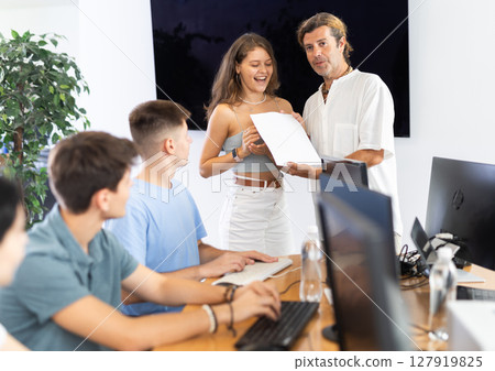 instructor hands diploma 127919825