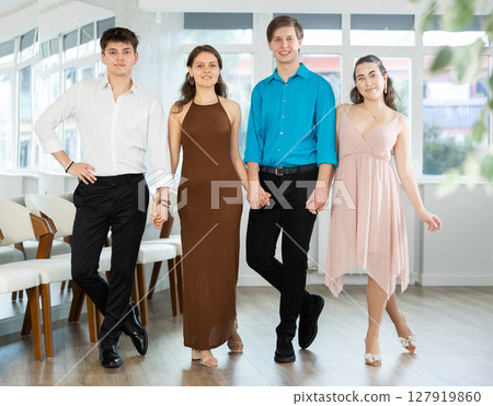 Girls and guy dancing folk dance in row in dance studio 127919860