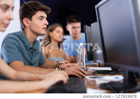 Concentrated junior software developer working in IT startup Concentrated junior software developer working in IT startup 127919878