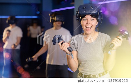girl is exhilarated by turn of events in VR game and moved virtual reality glasses to forehead 127919923