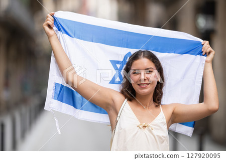 Young woman with Israeli flag on city street Young woman with Israeli flag on city street 127920095