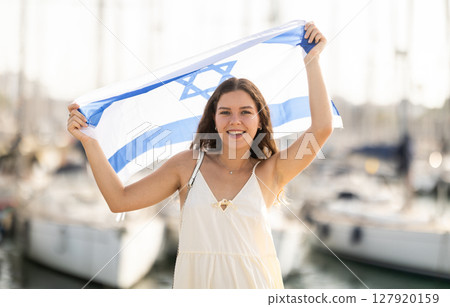 Young woman with Israeli flag at port Young woman with Israeli flag at port 127920159