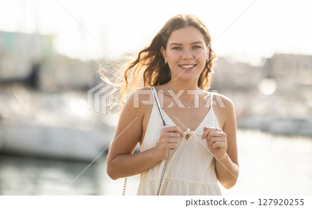 Young woman posing at yacht port 127920255
