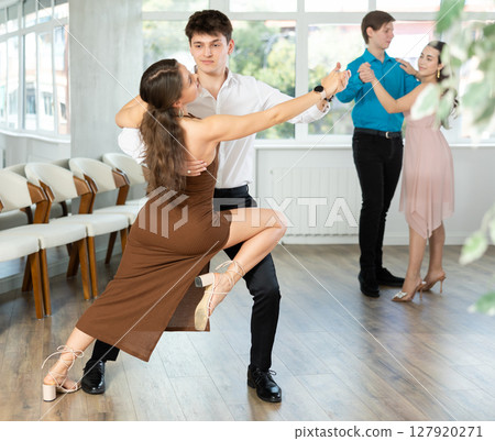 Tango performed by young couple in choreographic studio 127920271