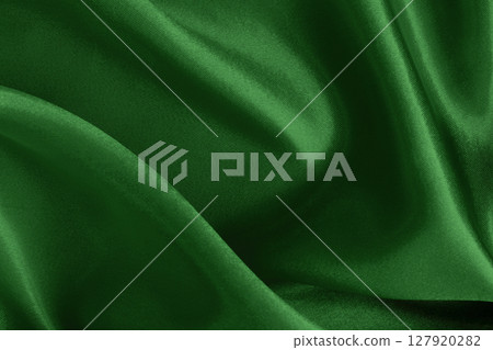 Dark green fabric cloth texture for background and design art work, beautiful crumpled pattern of silk or linen. 127920282