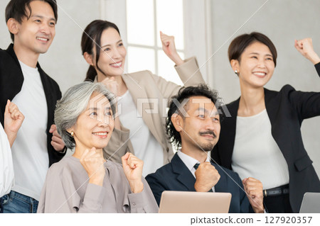 Career woman and businessman doing fist pump 127920357