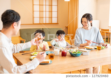 Image of a family having a meal at home 127920460