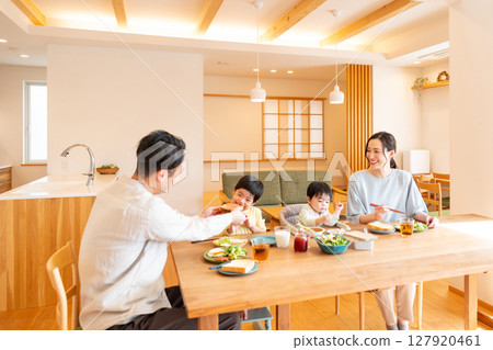 Image of a family having a meal at home Image of a family having a meal at home 127920461