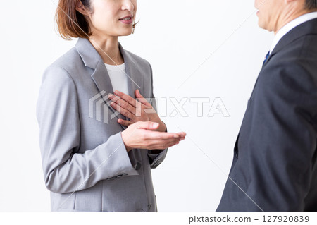 Middle-aged male businessman and female businesswoman in suits 127920839