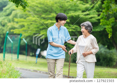 Senior woman and caregiver rehabilitation 127921503