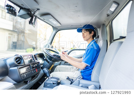 Young delivery staff driving Young delivery staff driving 127921993