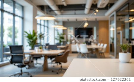 Modern office interior with sleek furniture and natural light creating productive atmosphere Modern office interior with sleek furniture and natural light creating productive atmosphere 127922261