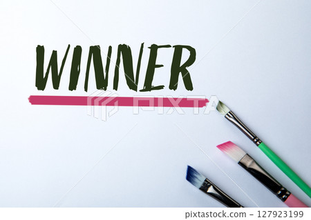 Winner Concept with Colorful Paintbrushes and Handwritten Text on White Background 127923199