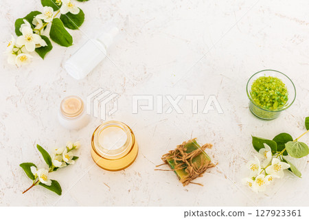 Body care products and branches of jasmine on the white background. 127923361
