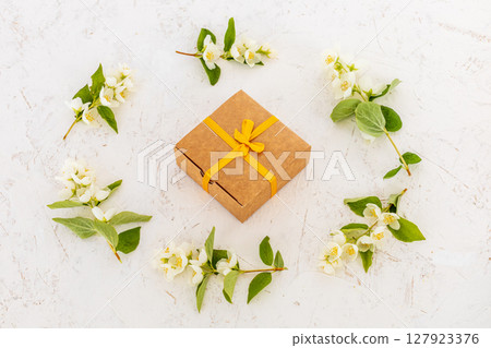 Gift box with flowers on the white background. Gift box with flowers on the white background. 127923376