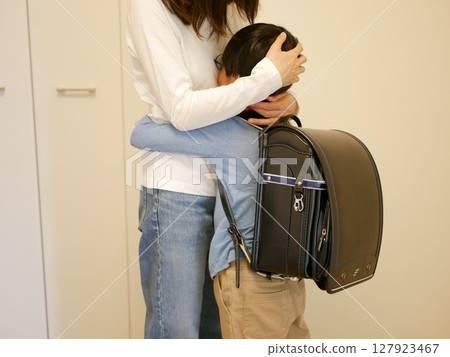 Boy hugged and comforted by his mother Boy hugged and comforted by his mother 127923467