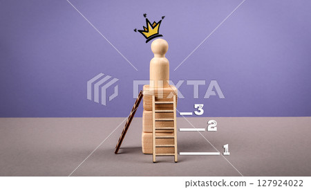 Leadership and Success Concept with Crowned Wooden Figure on Podium and Ranking Steps 127924022