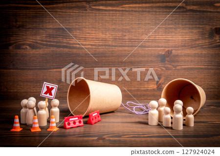 Communication Breakdown Concept with Barrier, Protest, and Divided Wooden Figures Communication Breakdown Concept with Barrier, Protest, and Divided Wooden Figures 127924024