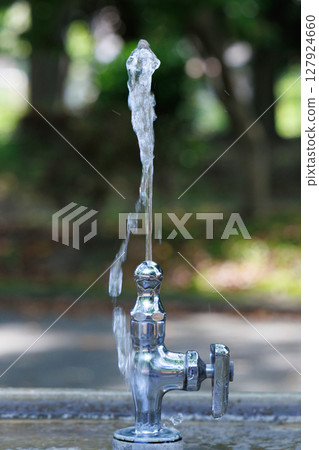 Flowing water at a drinking fountain in the park 127924660