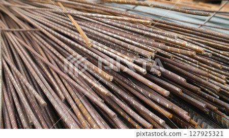 Steel reinforcement for concrete reinforcement. Pile of steel rebars stacked on a construction site Steel reinforcement for concrete reinforcement. Pile of steel rebars stacked on a construction site 127925321