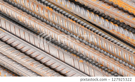 Steel reinforcement for concrete reinforcement. Pile of steel rebars stacked on a construction site 127925322