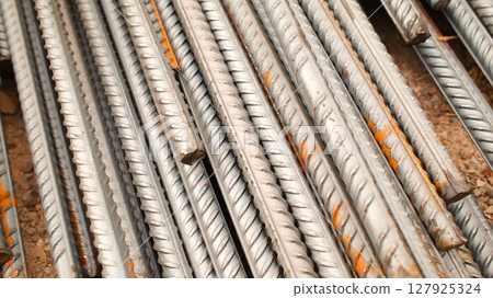 Steel reinforcement for concrete reinforcement. Pile of steel rebars stacked on a construction site Steel reinforcement for concrete reinforcement. Pile of steel rebars stacked on a construction site 127925324