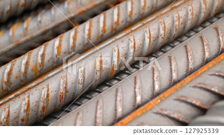 Steel reinforcement for concrete reinforcement. Pile of steel rebars stacked on a construction site Steel reinforcement for concrete reinforcement. Pile of steel rebars stacked on a construction site 127925339