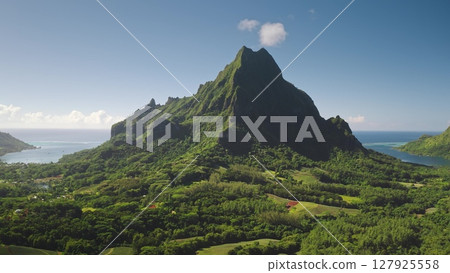 Aerial drone stunning beauty of Moorea, French Polynesia, with mountain rotui towering over the lush green landscape and tranquil Opunohu bay. Remote wild nature paradise, exotic summer travel Aerial drone stunning beauty of Moorea, French Polynesia, with mountain rotui towering over the lush green landscape and tranquil Opunohu bay. Remote wild nature paradise, exotic summer travel 127925558