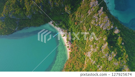 Breathtaking aerial view showcasing the pristine beauty of Mu Ko Ang Thong National Park in Thailand, featuring crystal-clear turquoise waters, lush tropical vegetation, and a secluded beach Breathtaking aerial view showcasing the pristine beauty of Mu Ko Ang Thong National Park in Thailand, featuring crystal-clear turquoise waters, lush tropical vegetation, and a secluded beach 127925674