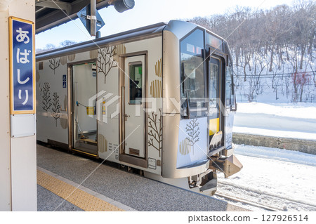 Abashiri City, Hokkaido - The platform at Abashiri Station in winter with a train on the Senmo Main Line entering the station Abashiri City, Hokkaido - The platform at Abashiri Station in winter with a train on the Senmo Main Line entering the station 127926514