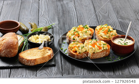deviled egg salad and red caviar on toast deviled egg salad and red caviar on toast 127926548