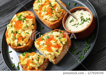deviled egg salad and red caviar on toast deviled egg salad and red caviar on toast 127926549