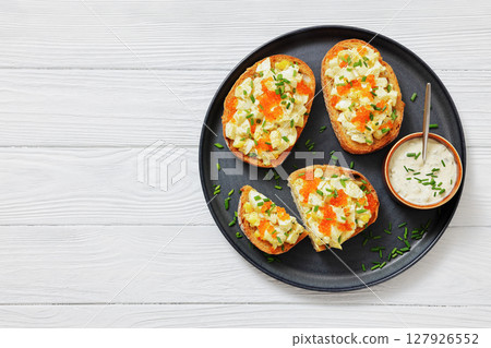 deviled egg salad and red caviar on toast 127926552