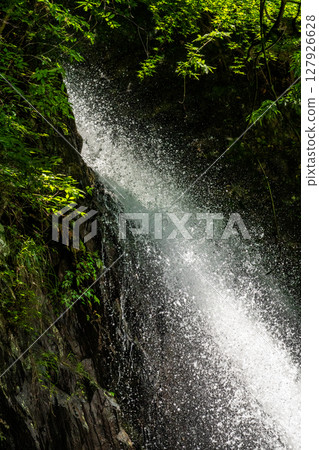 A midsummer valley and the splashes of a waterfall A midsummer valley and the splashes of a waterfall 127926628