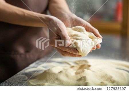 Woman shapes dough kitchen working carefully preparing homemade pizza 127928397