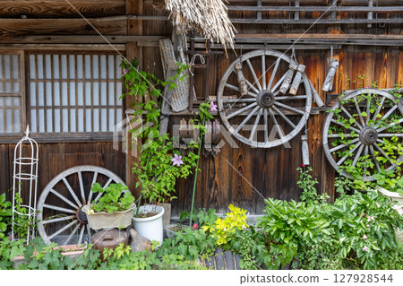 Shirakawa-go old houses and wheel decorations, early summer plants 127928544