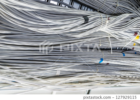 bunch of network cables in wave pattern leading across server ro 127929115