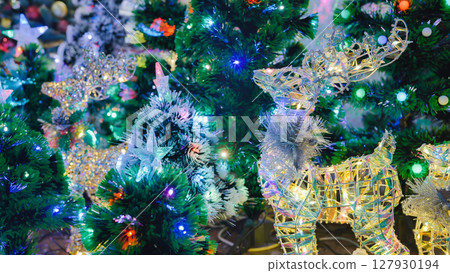 Christmas reindeer and tree figures glowing with colorful lights 127930194